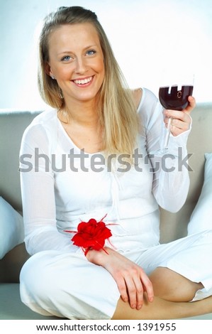Pretty young blond women with glass of red wine