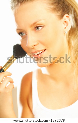 stock photo : Pretty blond girl doing makeup