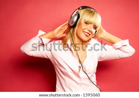 Young beautiful happy women listening music in headphones