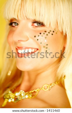 Portrait of beautiful young smiling woman with red lipstick and golden stars on chick