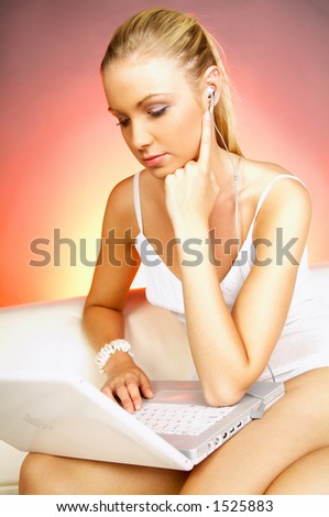 Portrait of a young woman working on laptop computer