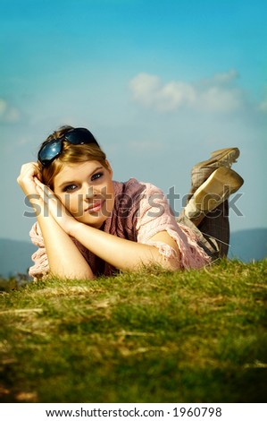 Young business woman relaxing on mouintain meadow