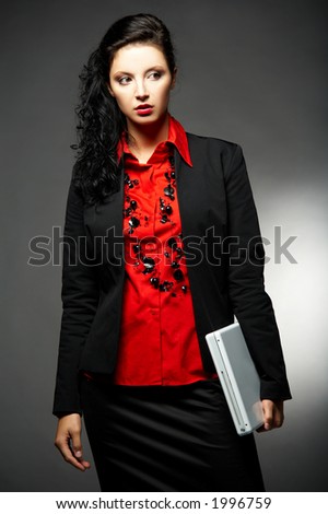 Young Business woman wearing red shirt and black jacket with laptop computer