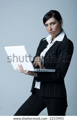 Beautiful brunette business woman with laptop computer isolated on clear background