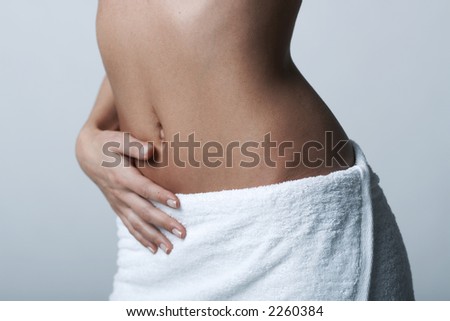 Beautiful womans body part wearing white towel on clear background