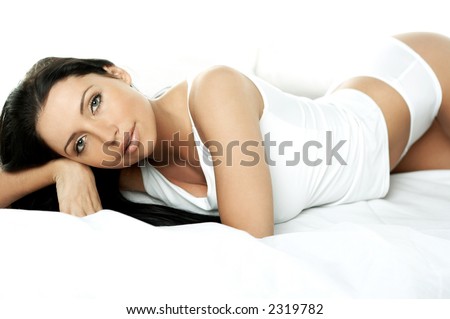 Portrait of Fresh and Beautiful brunette woman on bed
