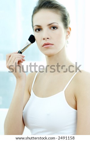 Portrait of Beautiful brunette woman doing daily morning routines (the make up series 2)