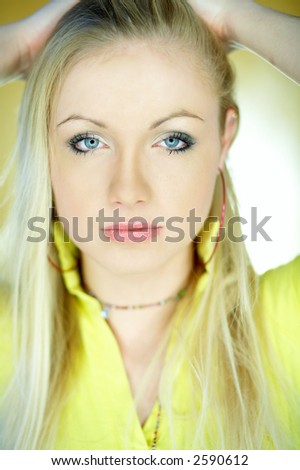 Portrait of beautiful blond woman wearing yellow shirt