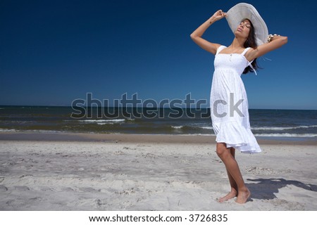 20-25 years old Beautiful Woman on the beach, wearing hat