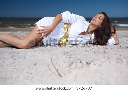 20-25 years old Beautiful Woman on the beach, wearing shirt