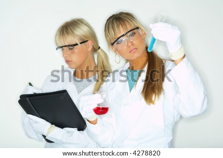 Beautiful female lab workers testing and experimenting
