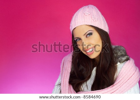 Portrait of beautiful woman wearing white sweater on pink