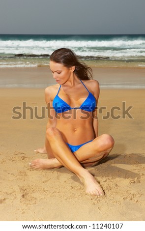 20-25 years old beautiful woman posing on beach