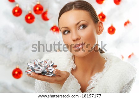 20-25 years old beautiful woman next to christmas tree on white background