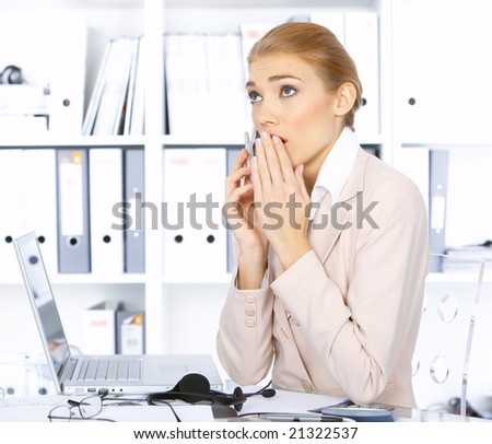 Worried beautiful business woman working in office, smiling