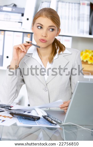 Beautiful business woman working in office, thinking