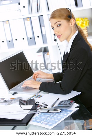 Happy Business woman working in office, wearing headset