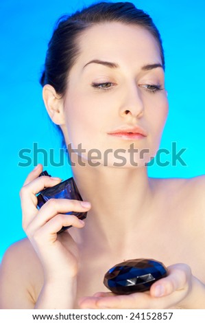 Portrait of 20-25 years old beautiful woman with bottle of perfume