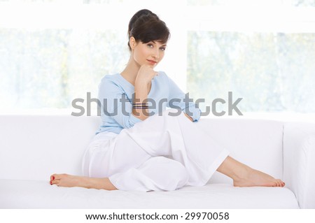 Young woman relaxing on couch in her home