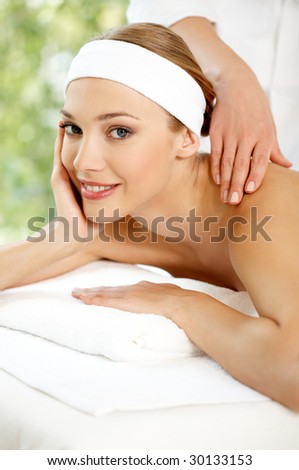 Young beautiful and relaxed lady taking spa treatment