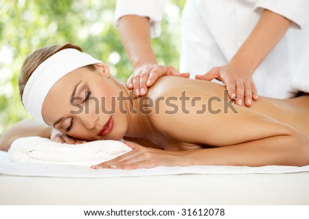 Young beautiful and relaxed lady taking spa treatment