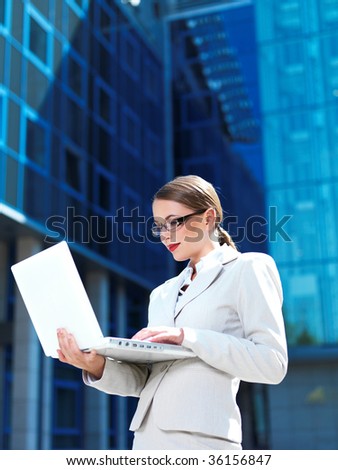 Beautiful business woman standing outdoor modern building