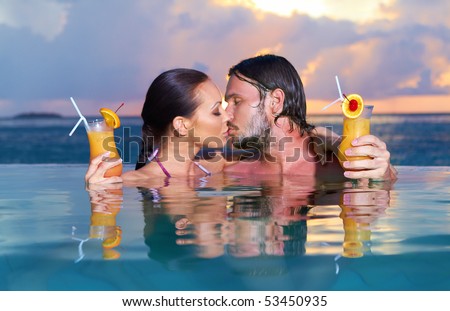 Romantic couple alone in infinity swimming pool