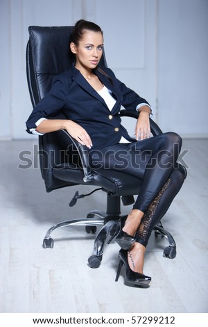 Portrait of beautiful business woman sitting on chair