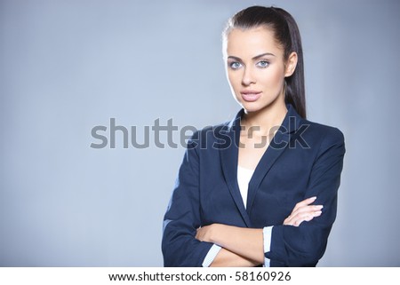 Portrait of beautiful business woman on gray background