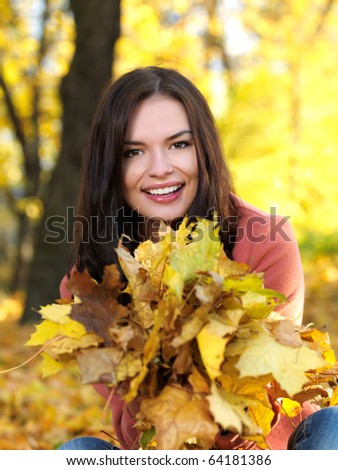Beautiful woman spending time in park during autumn season