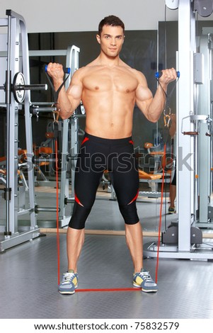 Handsome man at the gym doing exercises