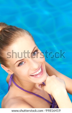 Close up of happy girl she standing in swimming pool