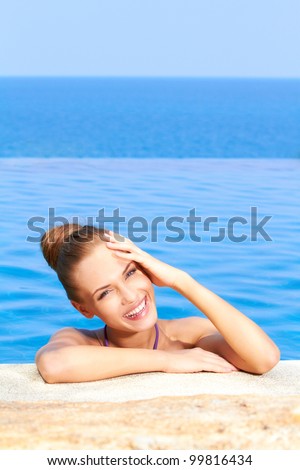 Close up of cute girl in infinity pool with copy space