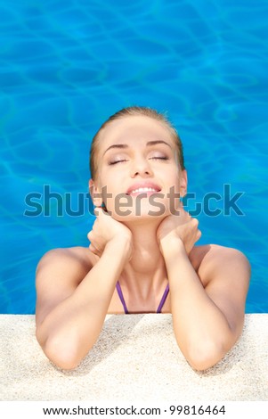 Dreaming woman with eyes closed in swimming pool