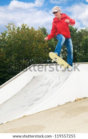 Cool granny on a skateboard at a skatepark