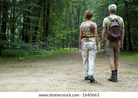 Senior couple hiking in the woods