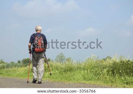 Senior man doing a Nordic Walk in the sun.