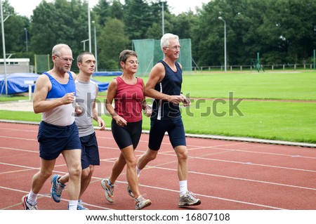 stock photo : Group of running people on a race track