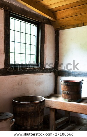 High contract image of an old room with cleaning buckets