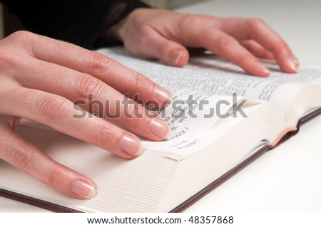 Woman\'s hands on a Bible, studying and reading.