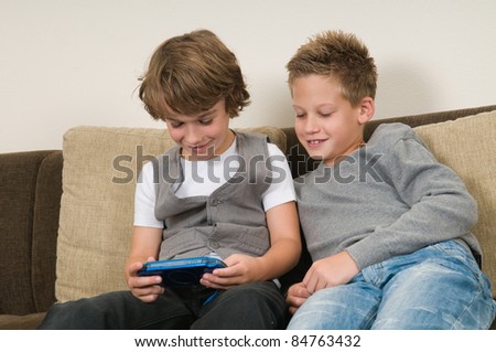 Two friends are playing a computer game on a gaming console