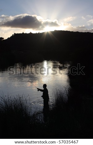 Fly fishing silhouette at sunrise