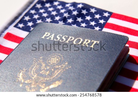 US passport over a red, white and blue flag background
