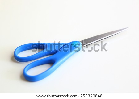 Blue scissor. Object is isolated on white background