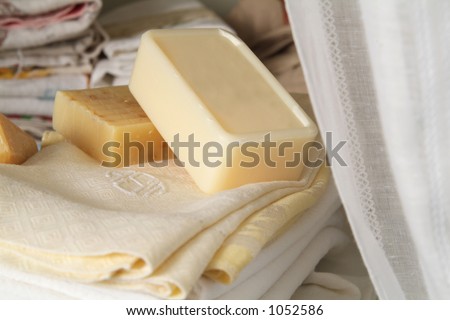 soap, kitchen towels and cloth napkins in a linen closet