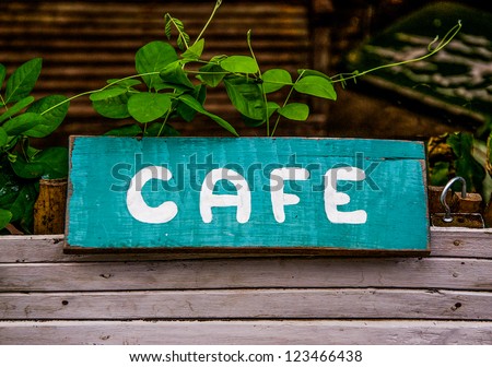 Old cafe sign on wooden