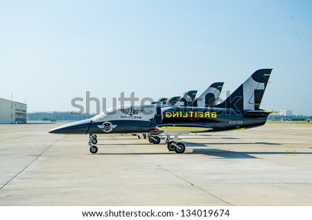BANGKOK THAILAND - MARCH 23 : The Acrobatic Britling Jet Team performed at event of Breitling Jet Team Under The Royal Sky at Royal Thai Airforce Base Donmuang on March 23, 2013, in Bangkok Thailand.