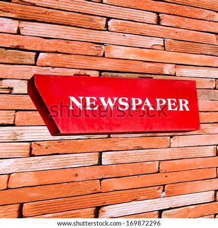 Newspaper box  on brickwall
