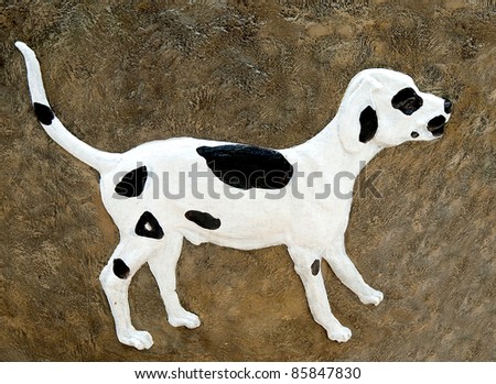The Carving dalmatian dog on wall background. This is traditional and generic style in Thailand. No any trademark or restrict matter in this photo.