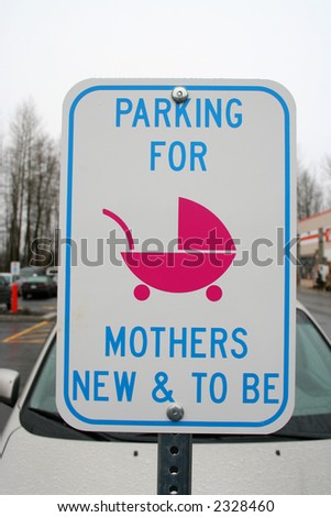 A sign informs mothers and mothers to be of a reserved parking stall.